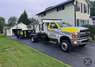 A tow truck is parked in front of a house.
